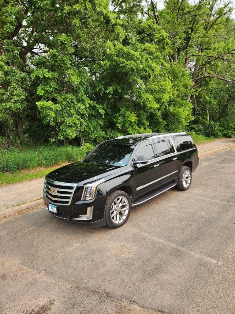 Chauffeured Escalade parked in serene location, part of CMB Transport’s luxury fleet serving VIPs, executives, and airport travelers throughout Minneapolis–St. Paul.